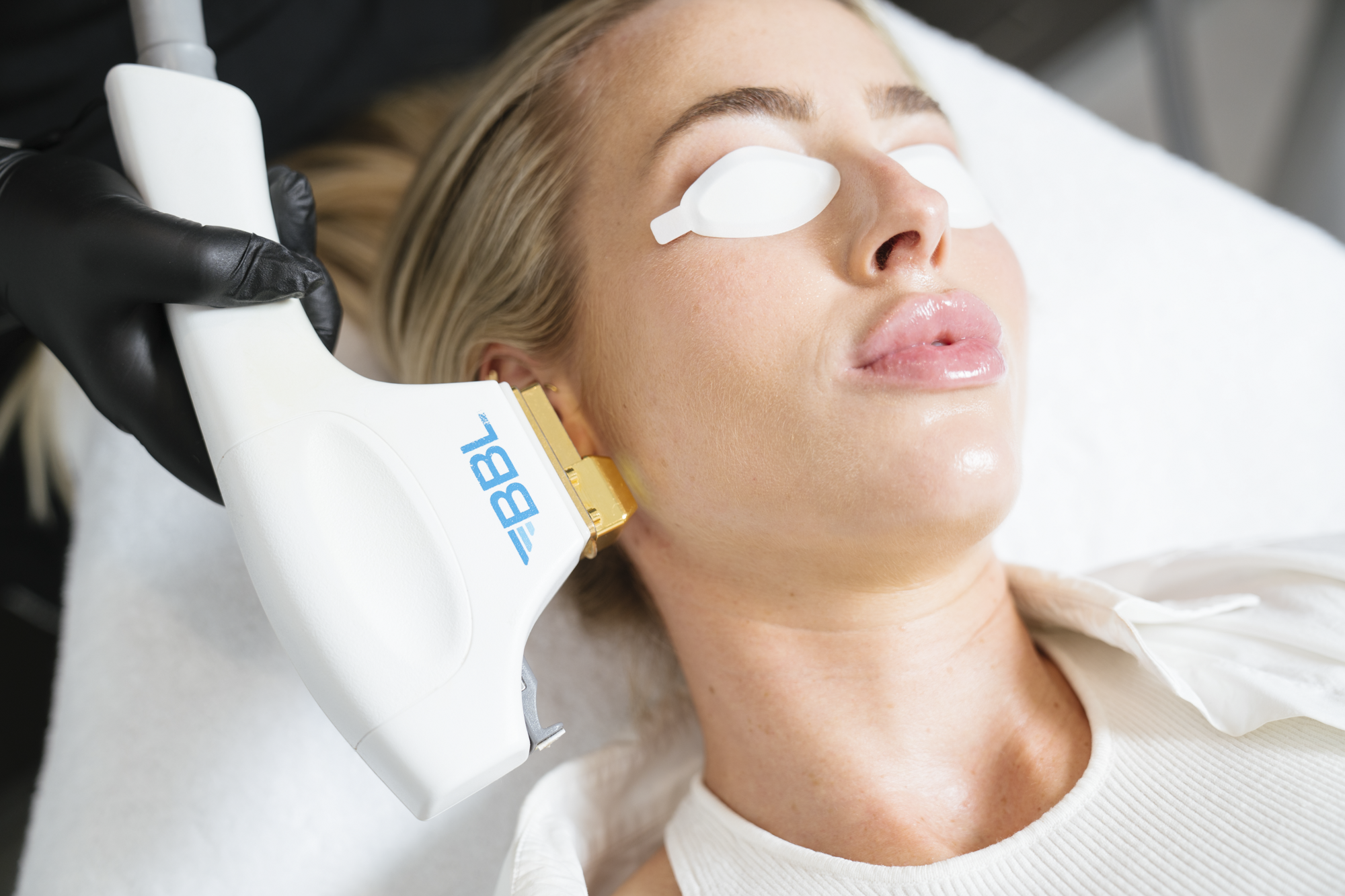 Woman receiving a facial treatment with a device on her face
